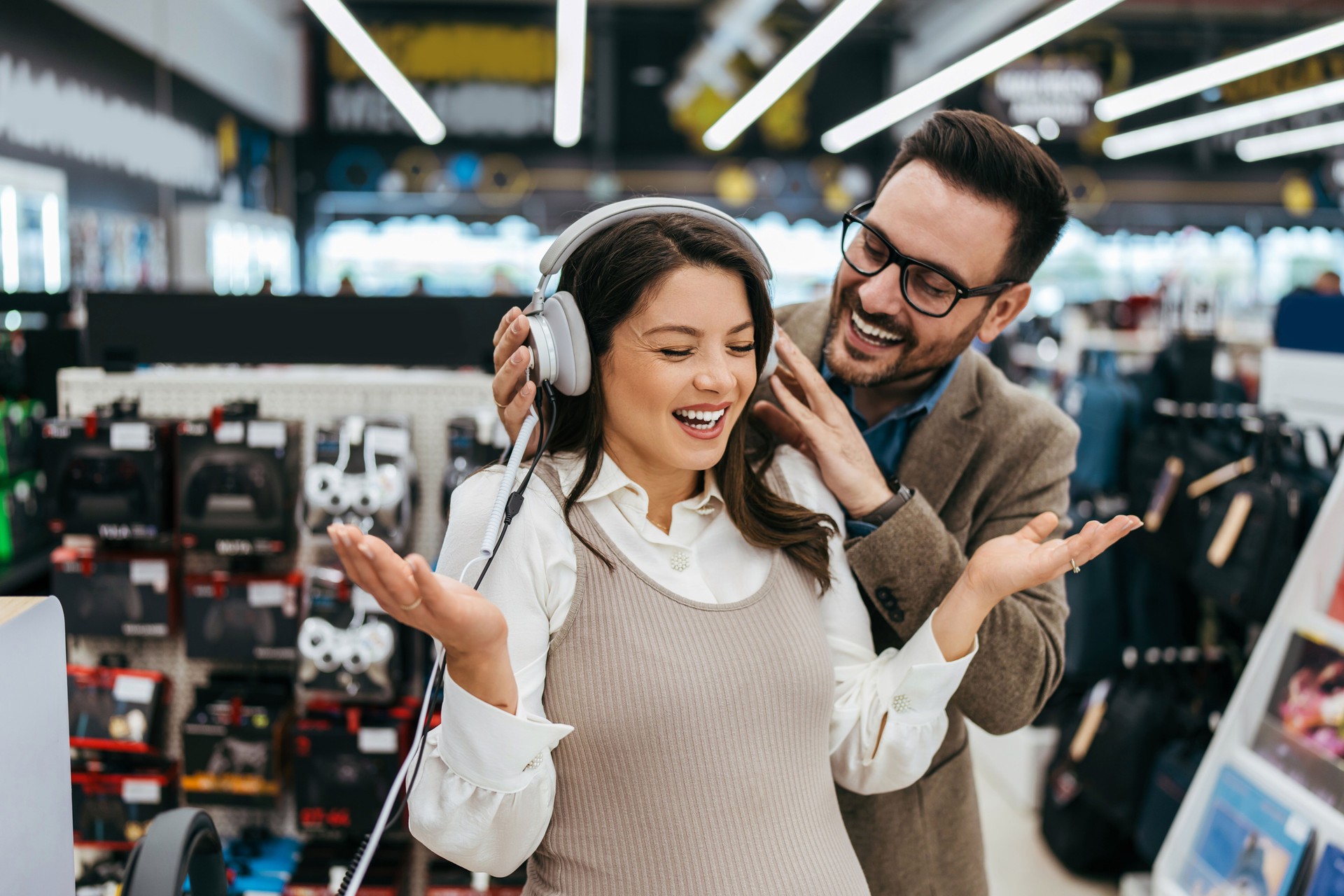 Young adult couple buyers in modern tech store.